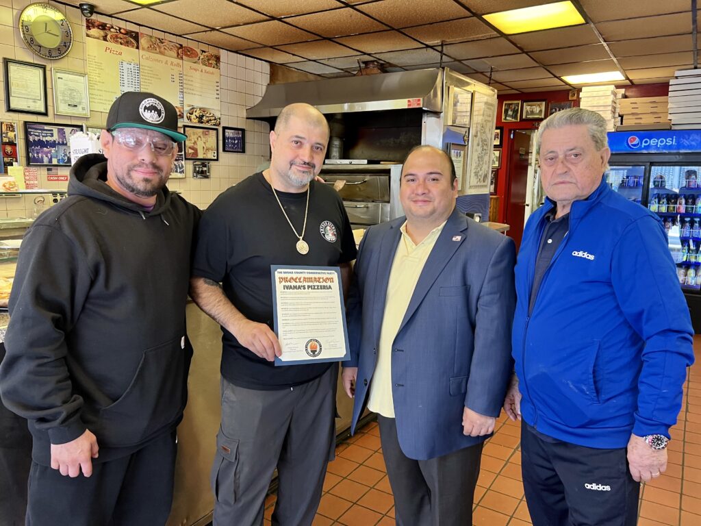 Gonzalo Duran giving Ivana's Pizzeria a Proclamation