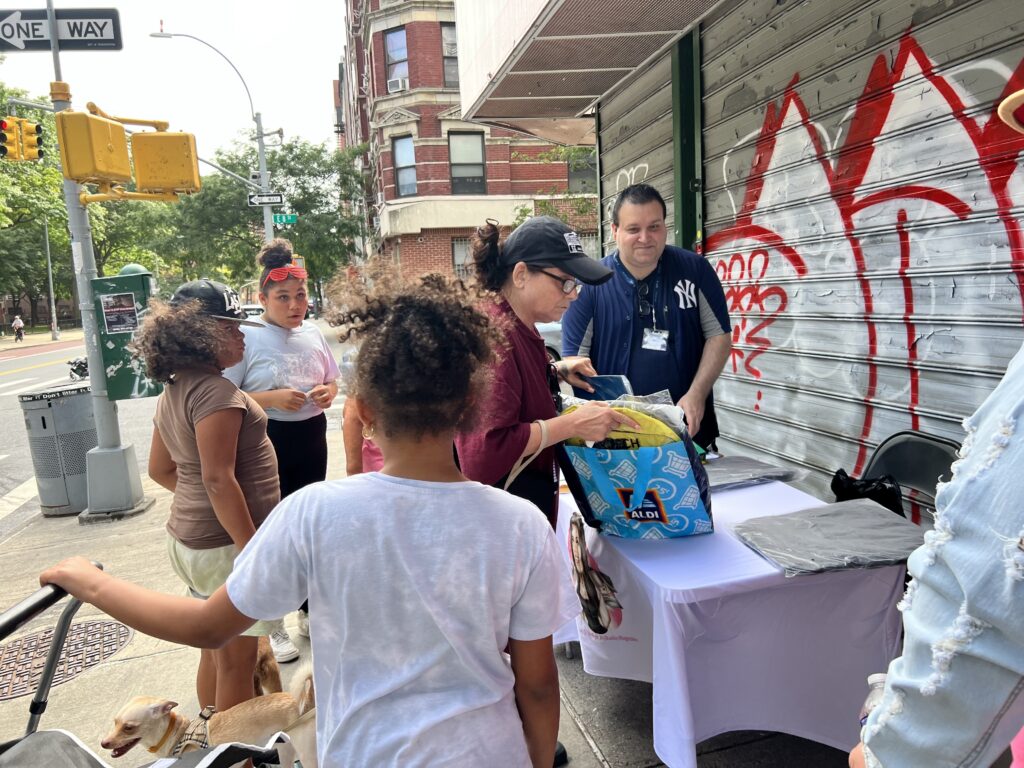 Jason Murillo giving out book bags for back to school event in District 2