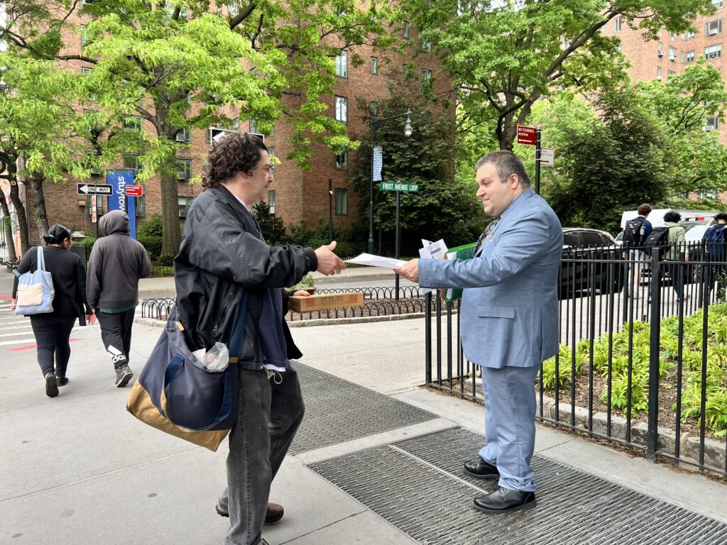 Jason Murillo giving out campaign pamphlets