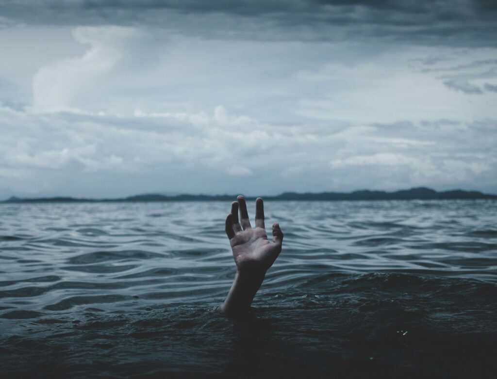 Hand coming out of the ocean.