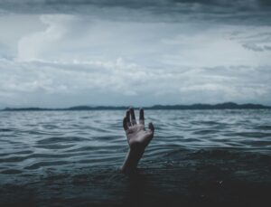 Hand coming out of the ocean.