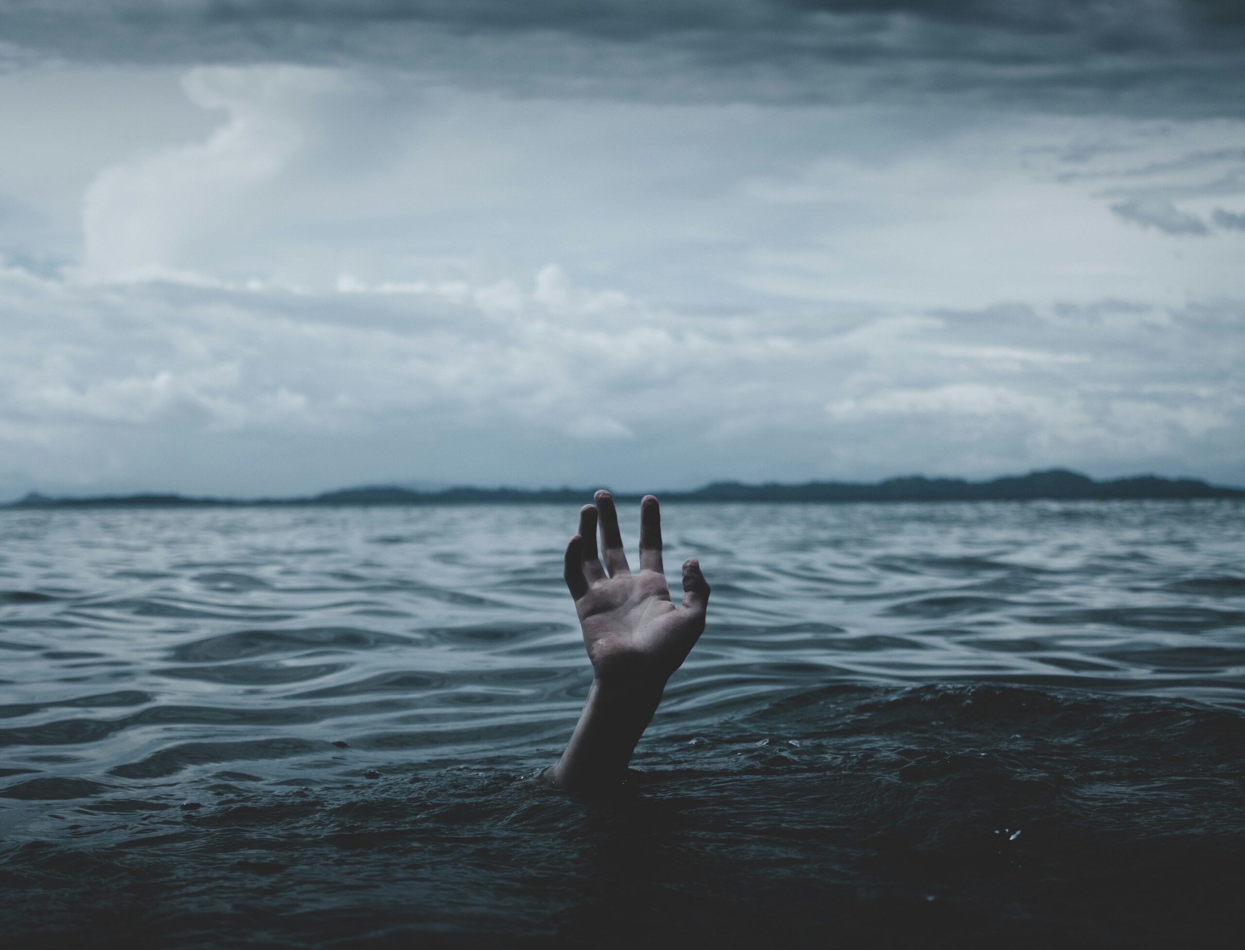 Hand coming out of the ocean.